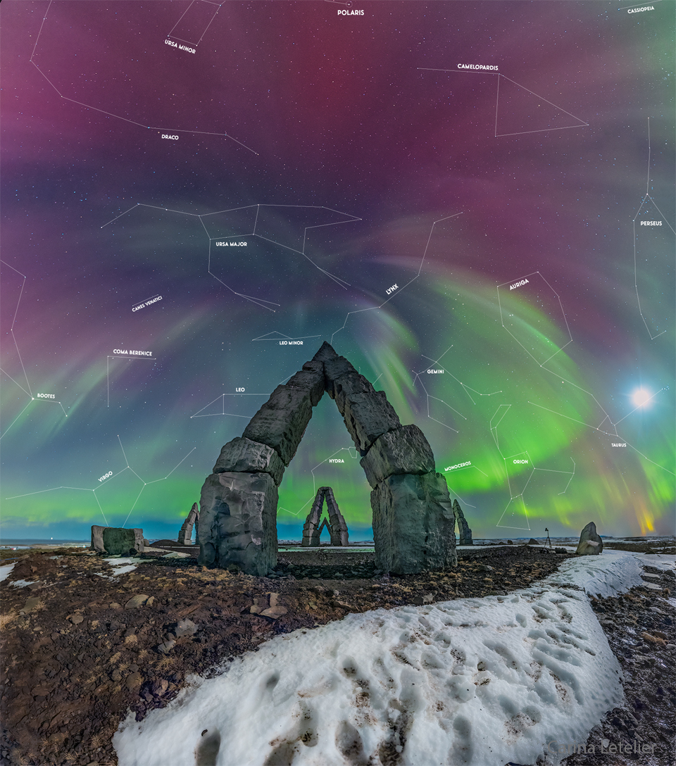 Multi-colored aurora are seen above an unusual stone
gateway, the first of several similar gateways seen in
the distance.
Please see the explanation for more detailed information.