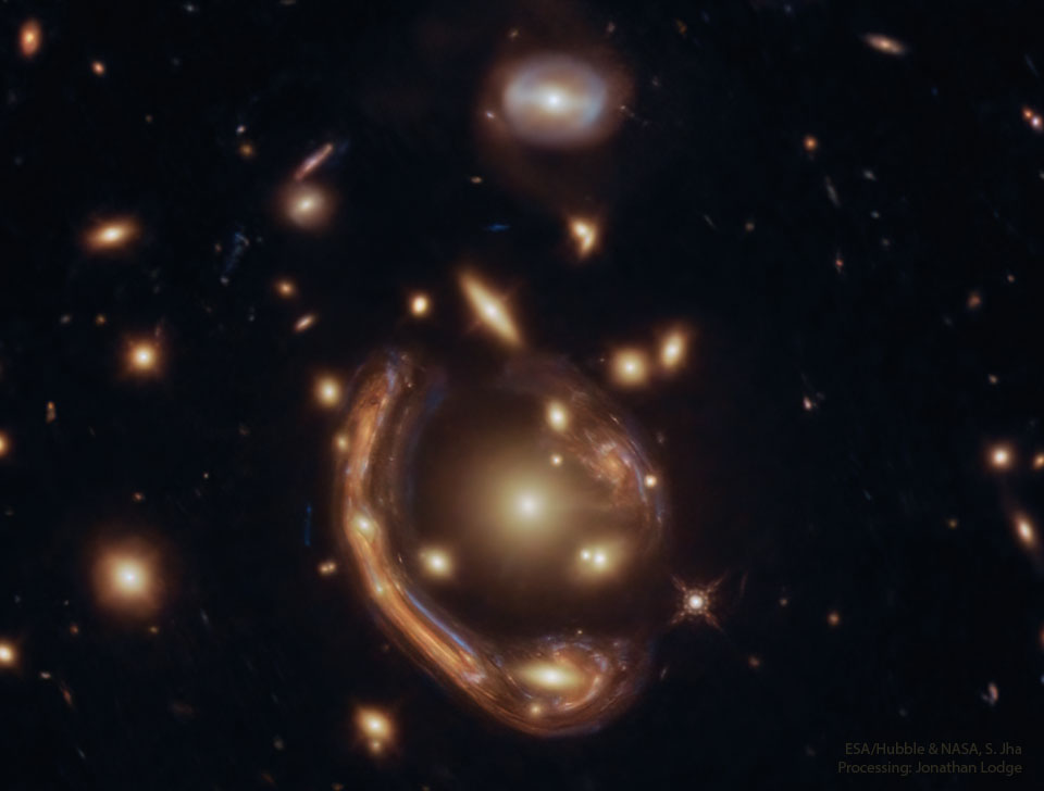 The featured image shows a distant galaxy distorted into
a giant arc around the center of a galaxy cluster by gravitational
lensing.
Please see the explanation for more detailed information.