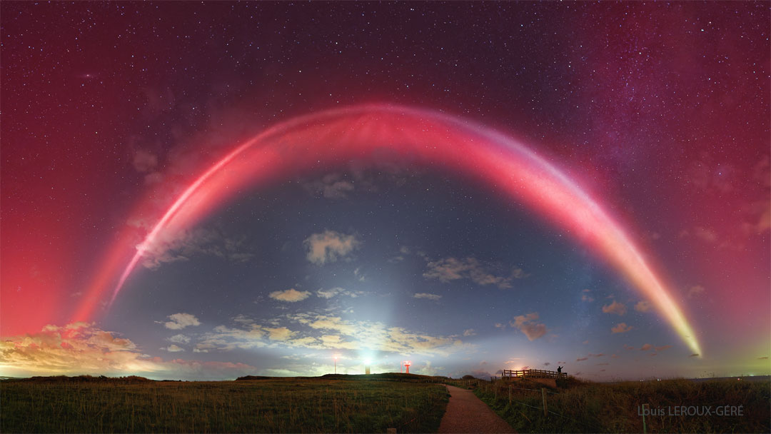 A night sky is shown with a bright red band running
overhead. Above the red band is a diffuse red glow.
A path through a grassy filed is in the foreground
with a path going out toward the horizon.
Please see the explanation for more detailed information.