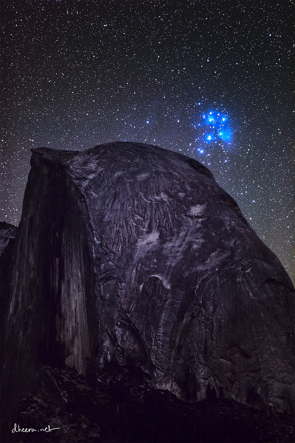 A cluster of bright blue stars is seen on the upper right
while an unusual dome-like mountain occupies most of the
frame.
Please see the explanation for more detailed information.