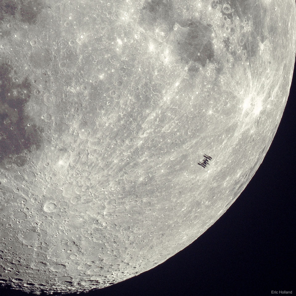A detailed view of part of Earth's Moon is shown with
many craters visible. On the lower right, silhouetted against
the comparatively bright Moon, is a small dark silhouette of
the International Space Station. Many of the solar panels on
the station are discernable.
Please see the explanation for more detailed information.