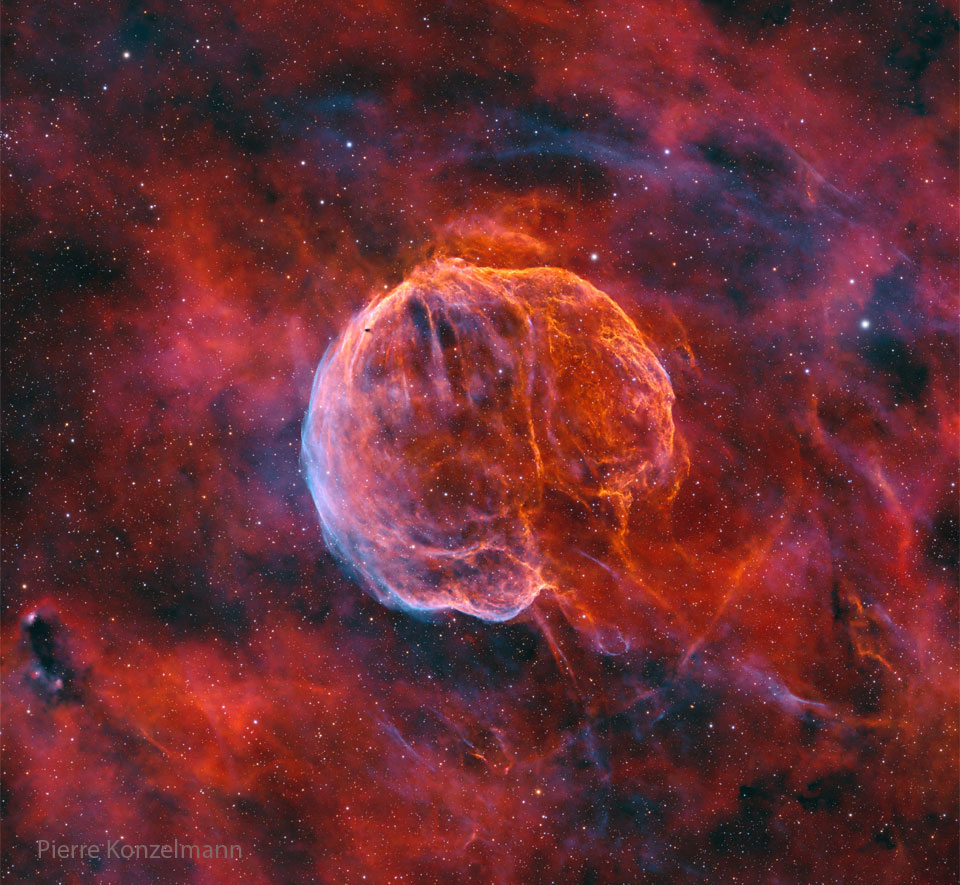 A colorful starfield surrounds a giant nearly-spherical
nebula that has texture and stripes like watermelon.
The lower right of the nebula is open making it appear
like a medulla oblongata -- the stem that connects to
a brain.
Please see the explanation for more detailed information.