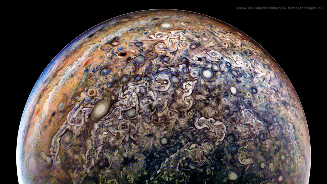 The planet Jupiter is shown from an unusual angle. Most
prominent are a miasma of jumbled and swirling clouds including
many oval storms.
Please see the explanation for more detailed information.