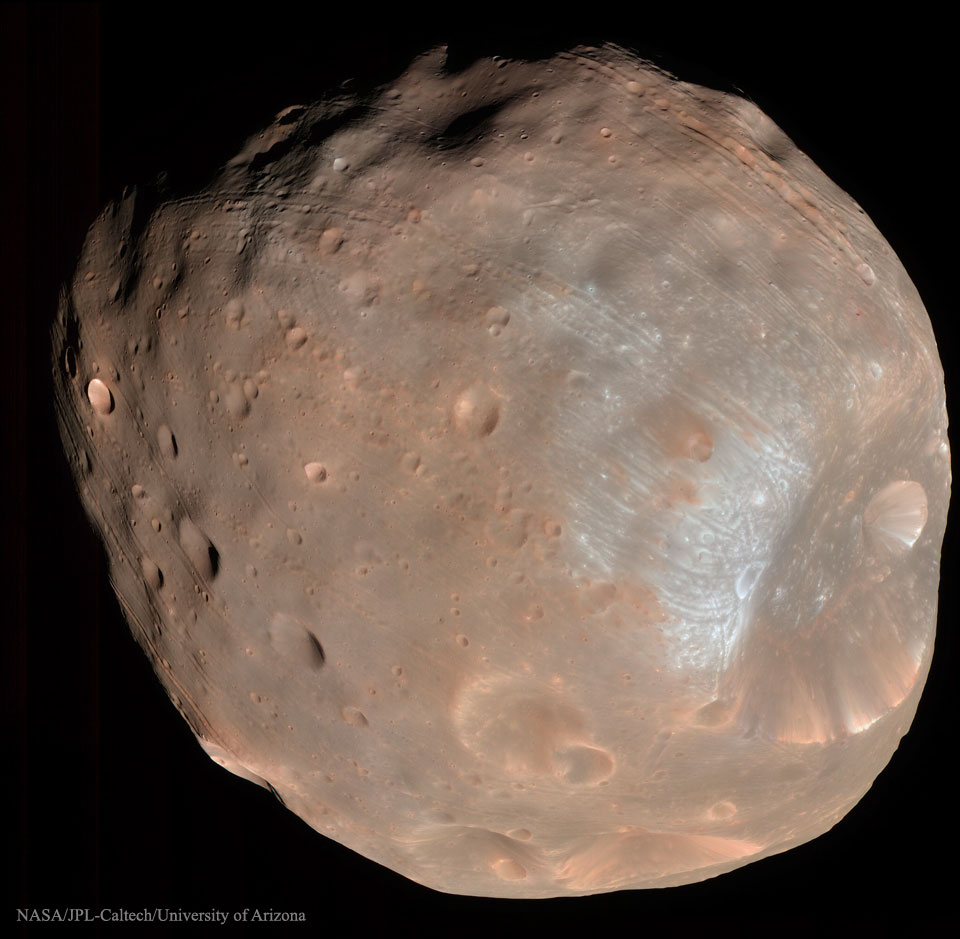 A large irregularly shaped object is shown that is mostly
brown and shows many craters.
Please see the explanation for more detailed information.