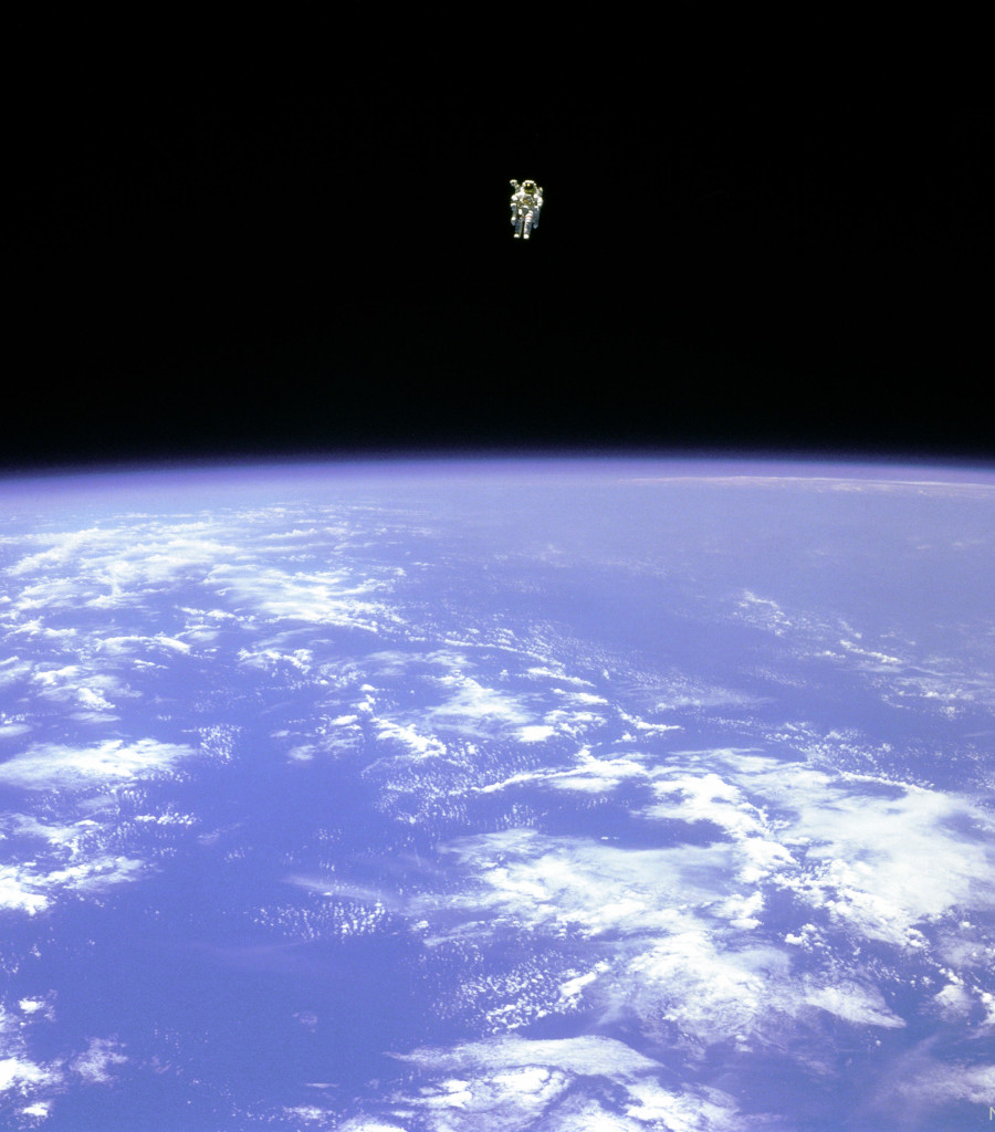 An astronaut is seen hovering over the Earth. In the
top part of the image, the astronaut is seen against the
darkness of space. In the lower part of the image, the
Earth is bright blue with white clouds.
Please see the explanation for more detailed information.