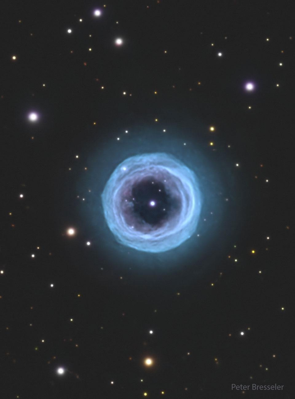 A starfield is shown with a large circular blue
ring in the center. In the ring's center is a bright
blue spot.
Please see the explanation for more detailed information.