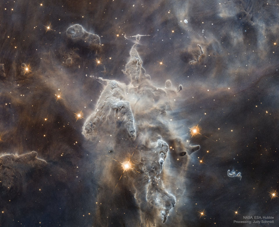 The featured image shows a large pillar of dust and
gas in the Carina Nebula. The pillar has many humps and
several jets.
Please see the explanation for more detailed information.