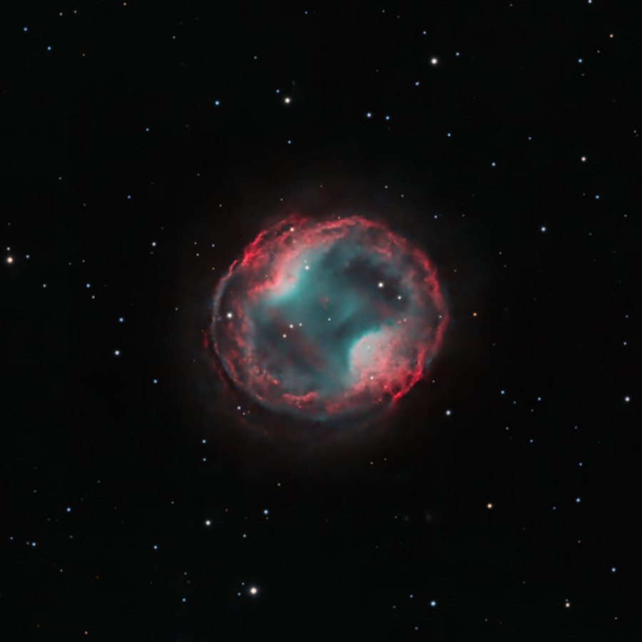 A bubble of gas occupies the center of the image with a few stars in the fore- and background. On opposite sides of the bubble, there are two
regions where the gas pinches inward. This makes the inner region of the nebula appear like a peanut inside a larger ring.