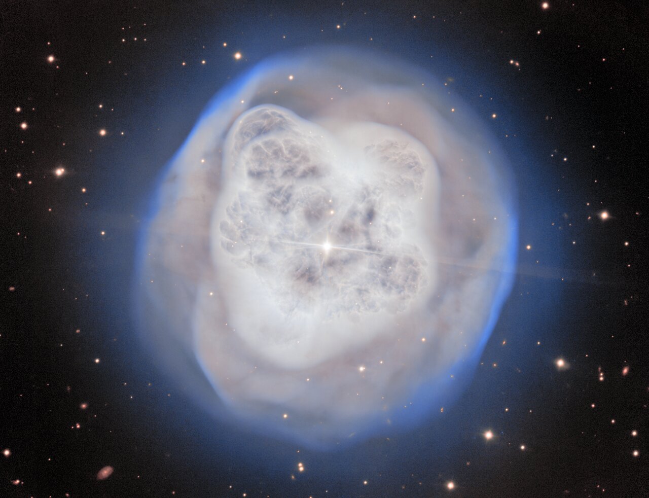 A white nebula over a black background with a
	  bright star in the center.