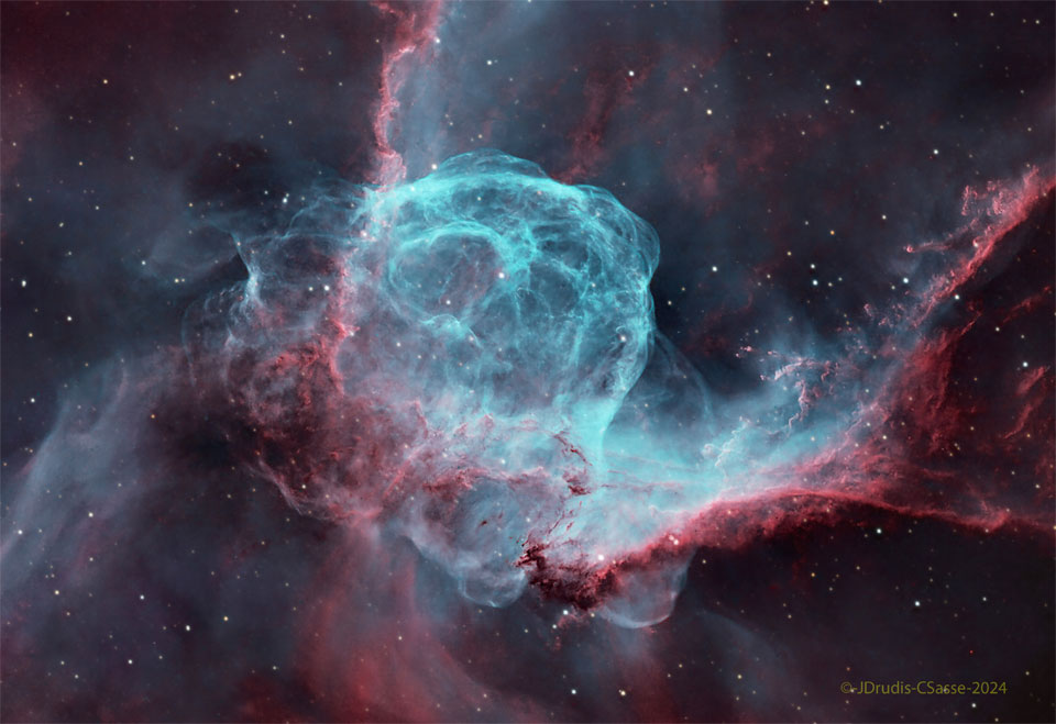 A starfield surrounds a complex nebula with many red
and blue filaments. Dark streams of dust also populate
the nebula.
Please see the explanation for more detailed information.