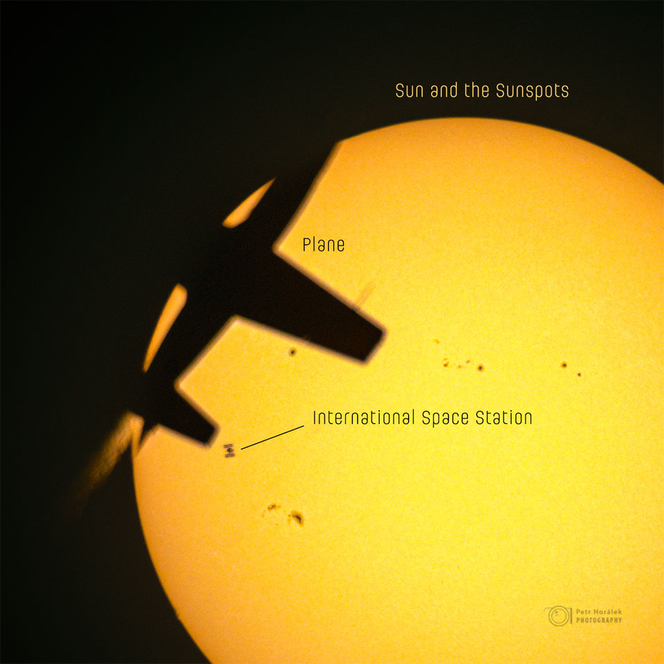 An image of the Sun is shown with several dark
silhouettes superposed. On the upper right is an
airplane, on the right is the International Space
Station, and across the Sun are several sunspots.
Please see the explanation for more detailed information.
